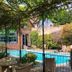 Ravenwood Hall Hotel in Bury St. Edmunds, garden patio with pool and vine-covered pergola