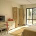 Diamonds Malindi guest room with sliding doors to a tropical balcony view in Malindi