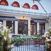 Åsby Hotell in Hallstahammar with snow-covered patio, string lights and red dormer windows