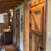 The Bed and Breakfast at Peace Hill Farm in Charles City: rustic hallway with barn-style wood door