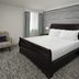 Hilton Washington DC/Rockville Executive Meeting Center guest room with king bed and chair in Rockville
