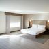 Holiday Inn & Suites Phoenix Airport by IHG guest room with king bed, sofa, and large window in Phoenix