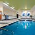 Indoor pool at Fairfield Inn & Suites by Marriott Seattle Bremerton in Bremerton with lounge chairs and large windows