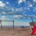 Hotel De La Plage in Valras-Plage with beach playground swings, slide and sea view under a cloudy sky