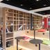 Ibis Strasbourg Sud La Vigie in Ostwald lounge with wooden shelves, tiered seating and colorful cushions