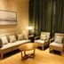 Clovelly Garden Hotel Shanghai lounge with sofa, two armchairs, coffee table and lamp