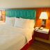 Hampton Inn & Suites by Hilton Cathedral City Palm Springs guest room with king bed and bedside lamps