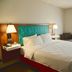 Hampton Inn & Suites by Hilton Cathedral City Palm Springs guest room with king bed and window chair