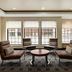 TownePlace Suites by Marriott Williamsport lobby seating area with chairs, table, and large street-facing windows