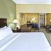 Country Inn & Suites by Radisson, Benton Harbor-St guest room with bed, sofa, TV, and desk