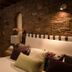 Villa Bella Bed & Breakfast Inn room with stone wall, striped headboard and layered pillows in La Cruz de Huanacaxtle