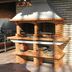 Brick barbecue grill area at Residencial Monte Carlo in Porto, with built-in cooking shelves