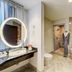 Hilton Motif Seattle bathroom with soaking tub, glass shower, and vanity