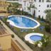 Apartamentos Vista Real in La Línea de la Concepción with outdoor pool, hot tub and palm-lined courtyard
