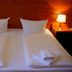 City Hotel am Kurfürstendamm, Berlin: double bed with white linens, towels, and bedside lamps