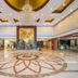 Zhucheng Huaxi Grand Hotel lobby in Rizhao with chandelier, marble floor medallion and mural wall