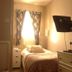 Balmoral Lodge Hotel Southport guest room with single bed, nightstand, and wall-mounted TV