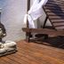 Thaiji Pousada e Parador in Florianopolis: Buddha statue on wooden deck beside lounge chair