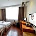Dunhe Apartment Guangzhou guest room with two twin beds, desk, TV, and window with curtains