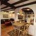 Casa Mia Suites in San Miguel de Allende dining area with wooden table, bar stools and exposed beams