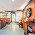 Ashbys Accommodation & Spa hire Portsmouth lobby lounge with red booths, piano and seating