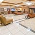 Holiday Inn Express & Suites Biloxi- Ocean Springs lobby with seating area and polished tile floors