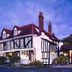 Marygreen Manor Hotel in Brentwood, Tudor-style exterior at dusk with lit windows and landscaped entrance