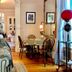 McCall House Boutique Inn in Ashland living area with dining table, hardwood floors and framed art
