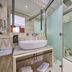 Son Sant Jordi in Pollença bathroom with vessel sink, frosted glass shower, and vanity