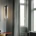 Boutique Hotel Hans Copenhagen room with gray sofa, tall windows and floor-length curtains