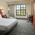 Courtyard by Marriott Aberdeen at Ripken Stadium guest room with king bed, seating area and window view