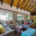 The Cavern in Bonjaneni lounge with sofas, chandelier and vaulted thatched ceiling