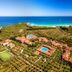 I Giardini di Cala Ginepro Hotel Resort in Cala Liberotto, aerial view with pools and sea