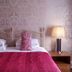 Hardwicke Hall Manor Hotel in Hartlepool bedroom with twin beds, pink bedding and bedside lamps