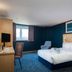 Travelodge Newbury Tot Hill room with double bed, desk, TV and a window view in Newbury