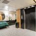 Royal Plaza Hotel Tiberias lobby with green sofa, round mirror and elevator doors