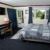 Governor's Rock Motel room in Shaftsbury with queen bed, desk, TV, and window view of greenery