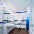 Travelodge Newbury Tot Hill bathroom with bathtub, toilet, sink, mirror and blue tile accents in Newbury.