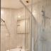 Lille City Hotel in Lille bathroom with glass shower, vanity sink, and wall mirror