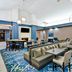 Homewood Suites by Hilton Dallas - Lewisville lobby lounge with seating area and patterned blue carpet