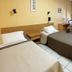 Hotel De La Plage in Valras-Plage: twin guest room with two single beds, desk, and window