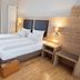 Hotel Haus Delecke room with double bed, wooden accents, and lakeside window in Möhnesee