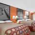 Super 8 by Wyndham Port Royal/Beaufort guest room with three beds and wall art in Port Royal