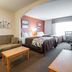 Sleep Inn & Suites Lake of the Ozarks in Camdenton room with two beds, sofa and desk