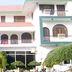 Hotel Buddha International in Bodh Gaya with arched balconies and lush garden landscaping