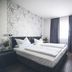 Gartenstadt Hotel room in Ludwigshafen am Rhein with twin beds, TV, desk and curtains