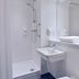 Travelodge Manchester Birch M62 Eastbound bathroom with shower, sink, mirror and toilet in Heywood