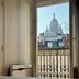 Villa Montmartre Paris room view of Sacré-Cœur through an open window and wrought-iron balcony
