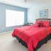 Villas at Seven Dwarfs Lane Resort Kissimmee bedroom with red bedspread, nightstands and window