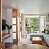 Crystalbrook Byron in Byron Bay, open-plan suite with sectional sofa and floor-to-ceiling forest view
